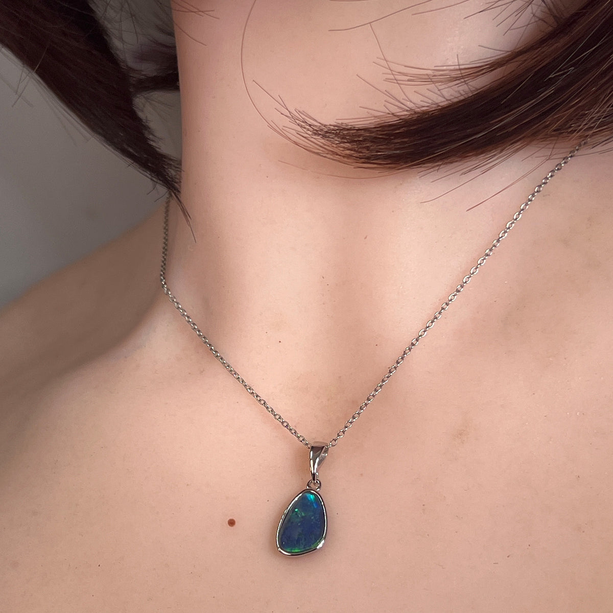 Worn Australian opal triplet pendant in sterling silver, blue and green, 12 x 8mm