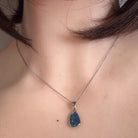 Australian opal triplet pendant worn at the neck, sterling silver, 12 x 8mm freeform stone