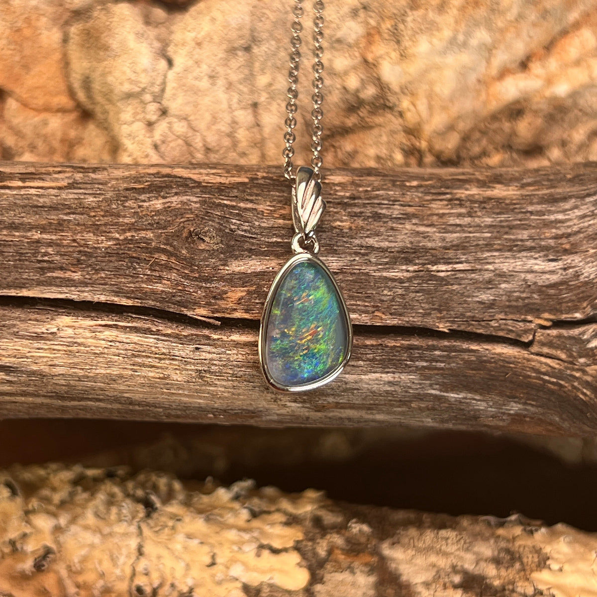 freeform Australian opal triplet pendant in sterling silver, blue, green and yellow play-of-colour