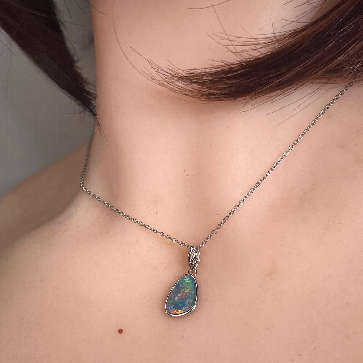 Worn Australian opal triplet pendant in sterling silver, blue, green and yellow, 12 x 8mm