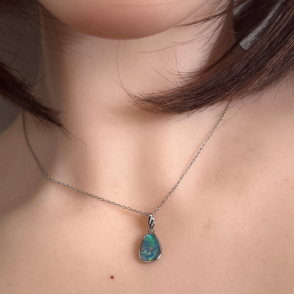 freeform Australian opal triplet pendant worn, sterling silver, blue, green and yellow
