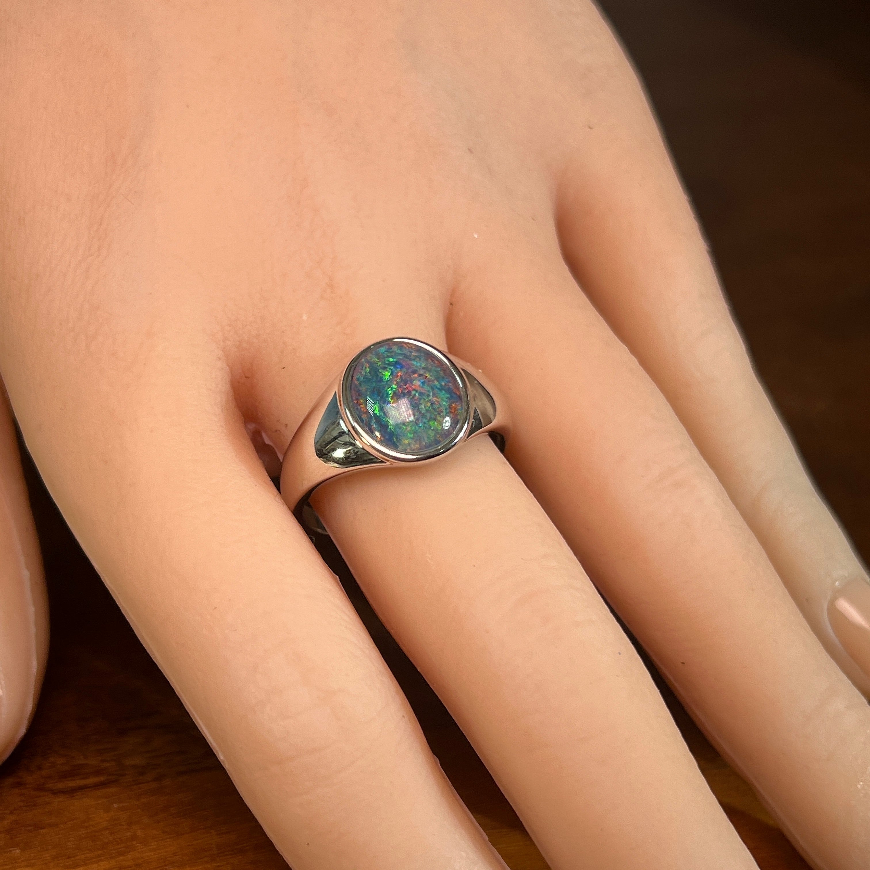 oval Australian opal triplet ring in sterling silver, worn on the hand