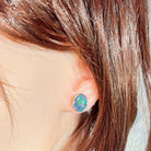 11 x 9mm oval Australian opal triplet earrings worn on the ear, sterling silver