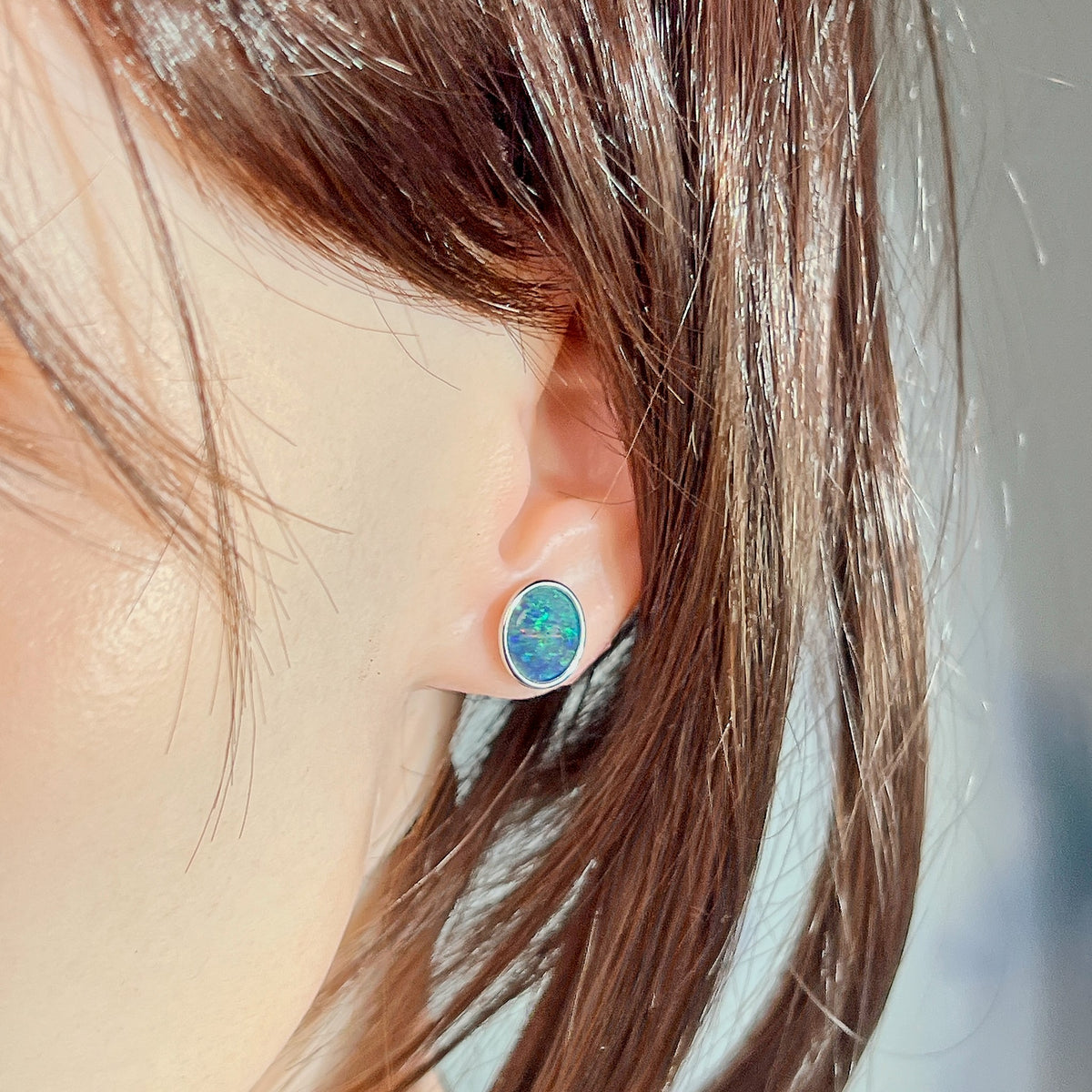 Worn Australian opal triplet earrings in sterling silver, blue and green, 11 x 9mm