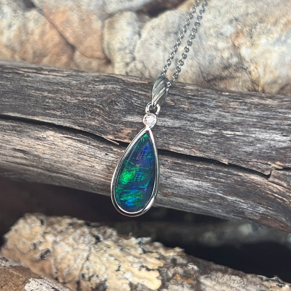 blue and green play-of-colour in a 16 x 8mm pear-shaped Australian opal triplet pendant