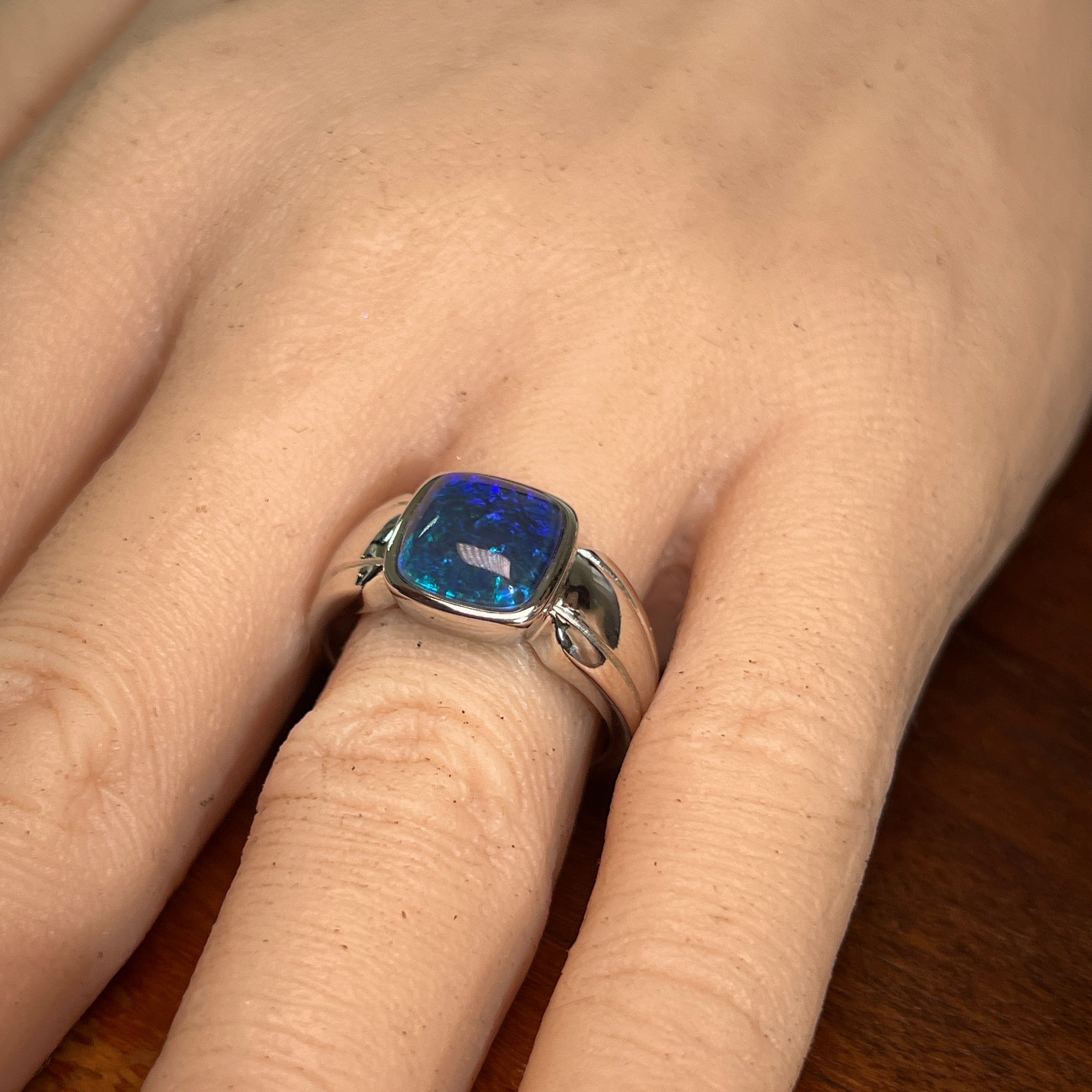 Australian opal triplet ring worn on the hand, blue play-of-colour