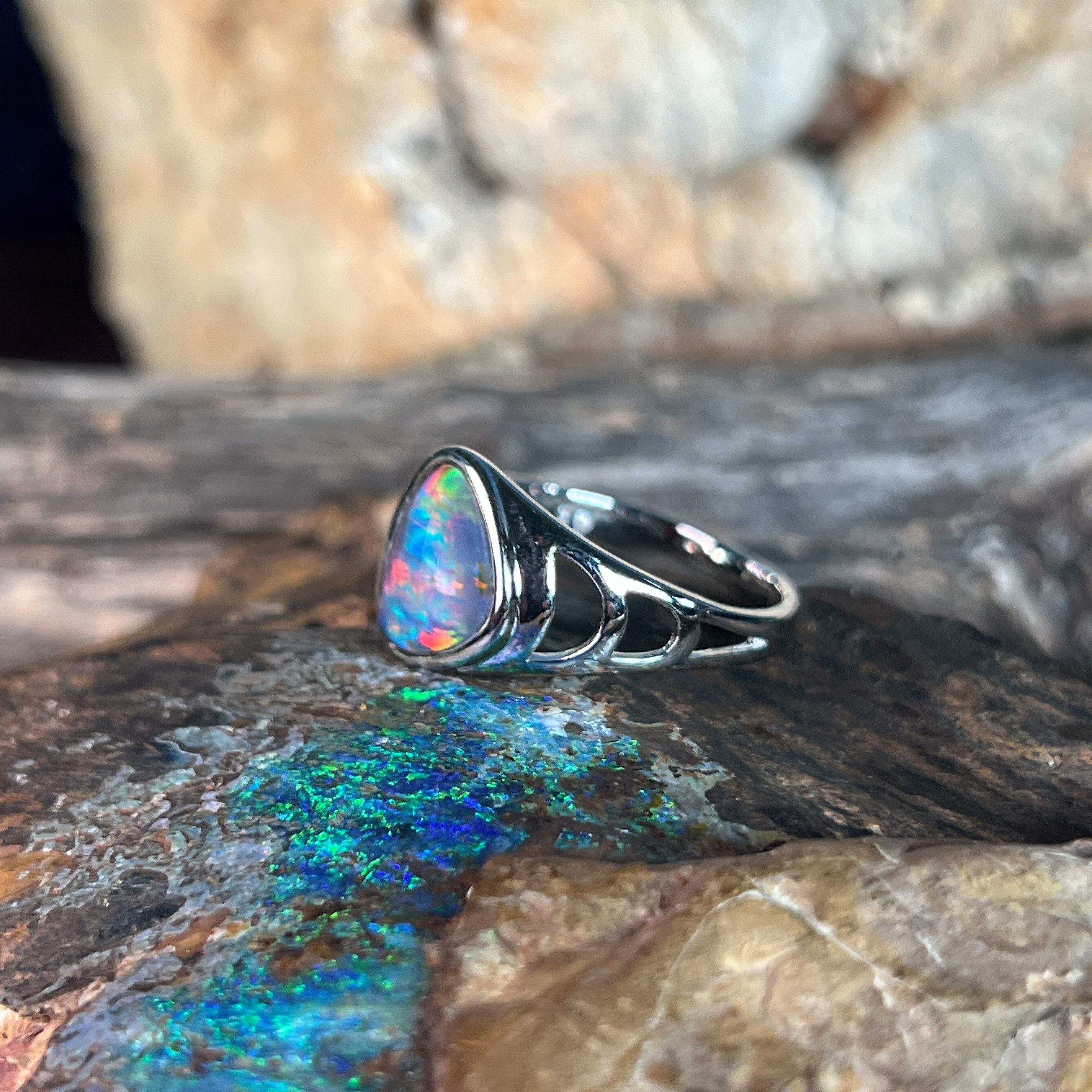 red, blue and green play-of-colour in a 12 x 9mm triangular Australian opal triplet ring