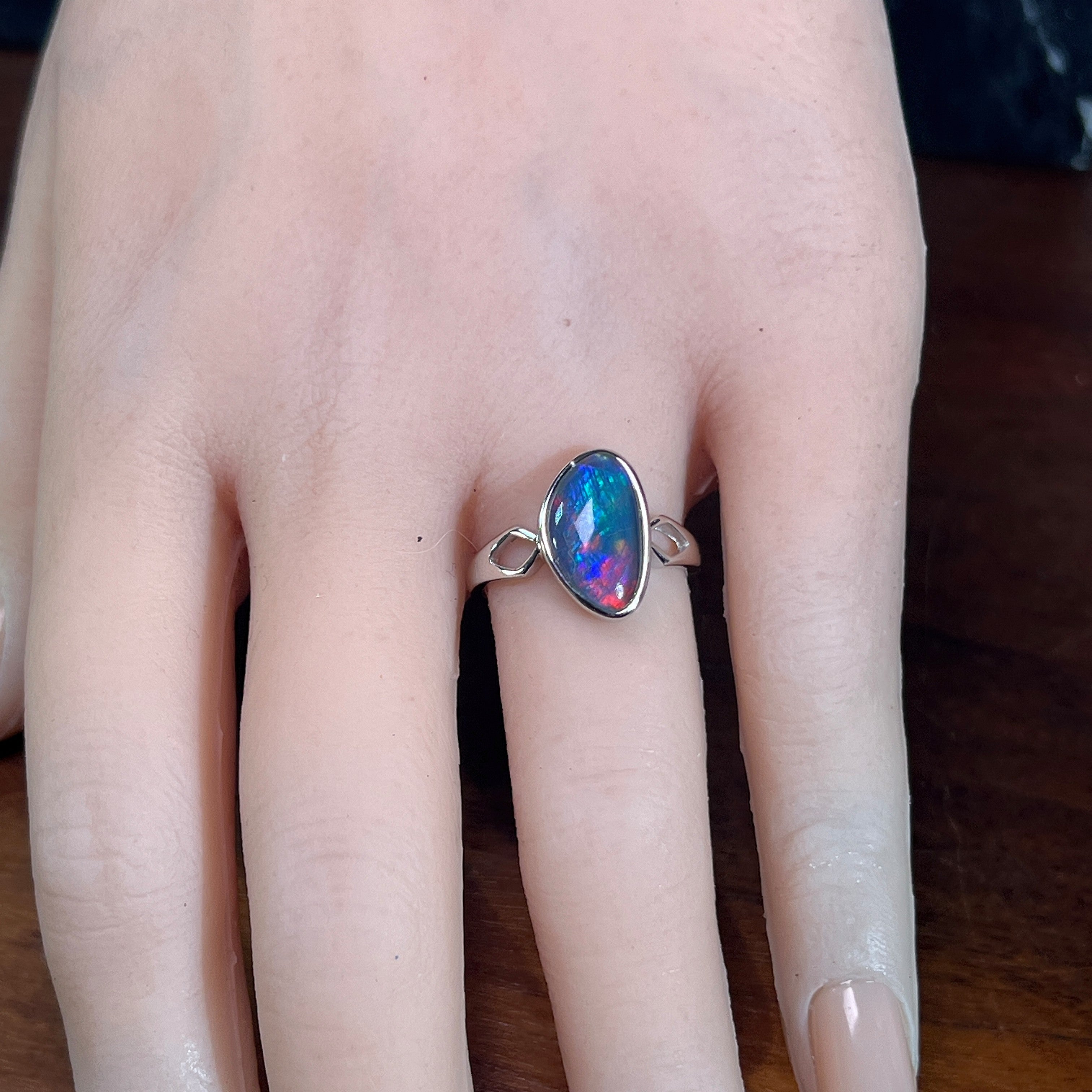 13 x 8mm triangular Australian opal triplet ring on the hand, sterling silver