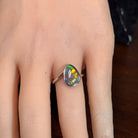 Australian opal triplet ring worn on the hand, red, yellow, blue and green play-of-colour