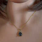 10x8mm opal triplet pendant worn at the neck on a fine gold-plated chain