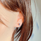 Opal triplet stud in gold-plated silver worn on the ear, side profile view