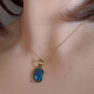 14x10mm opal triplet pendant worn at the neck, showing its scale on the collarbone