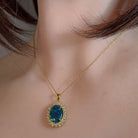 14x10mm opal triplet halo pendant worn at the neck, showing its scale on the collarbone
