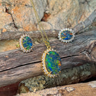 18x13mm oval opal triplet halo pendant with matching studs, showing green and red fire