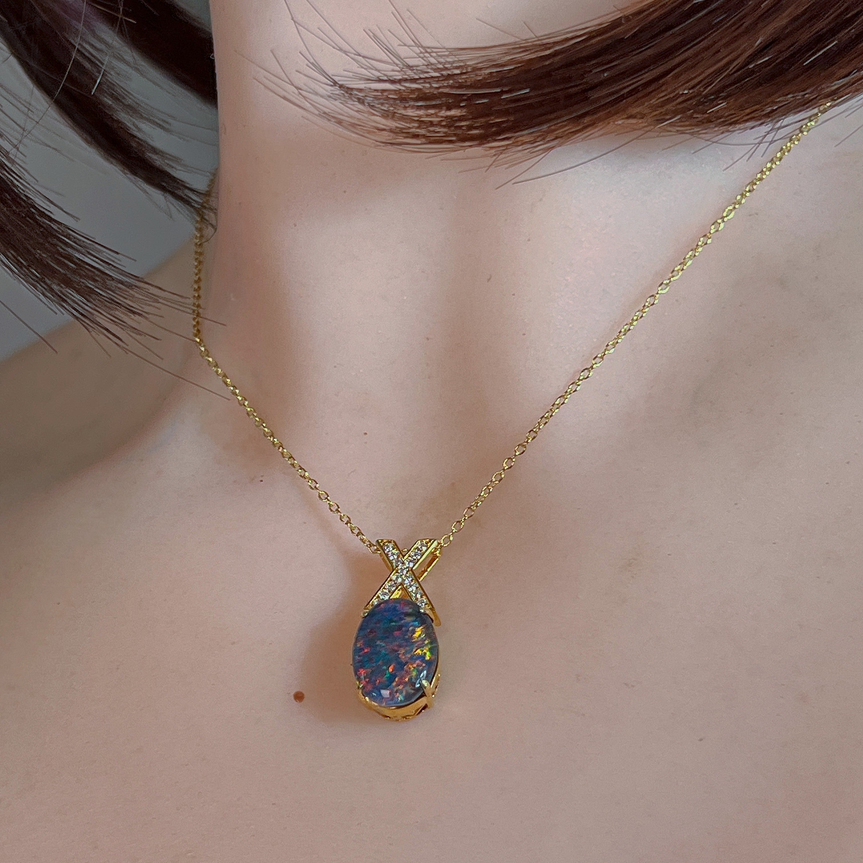 Yellow gold-plated opal triplet pendant worn on a fine chain at the neckline