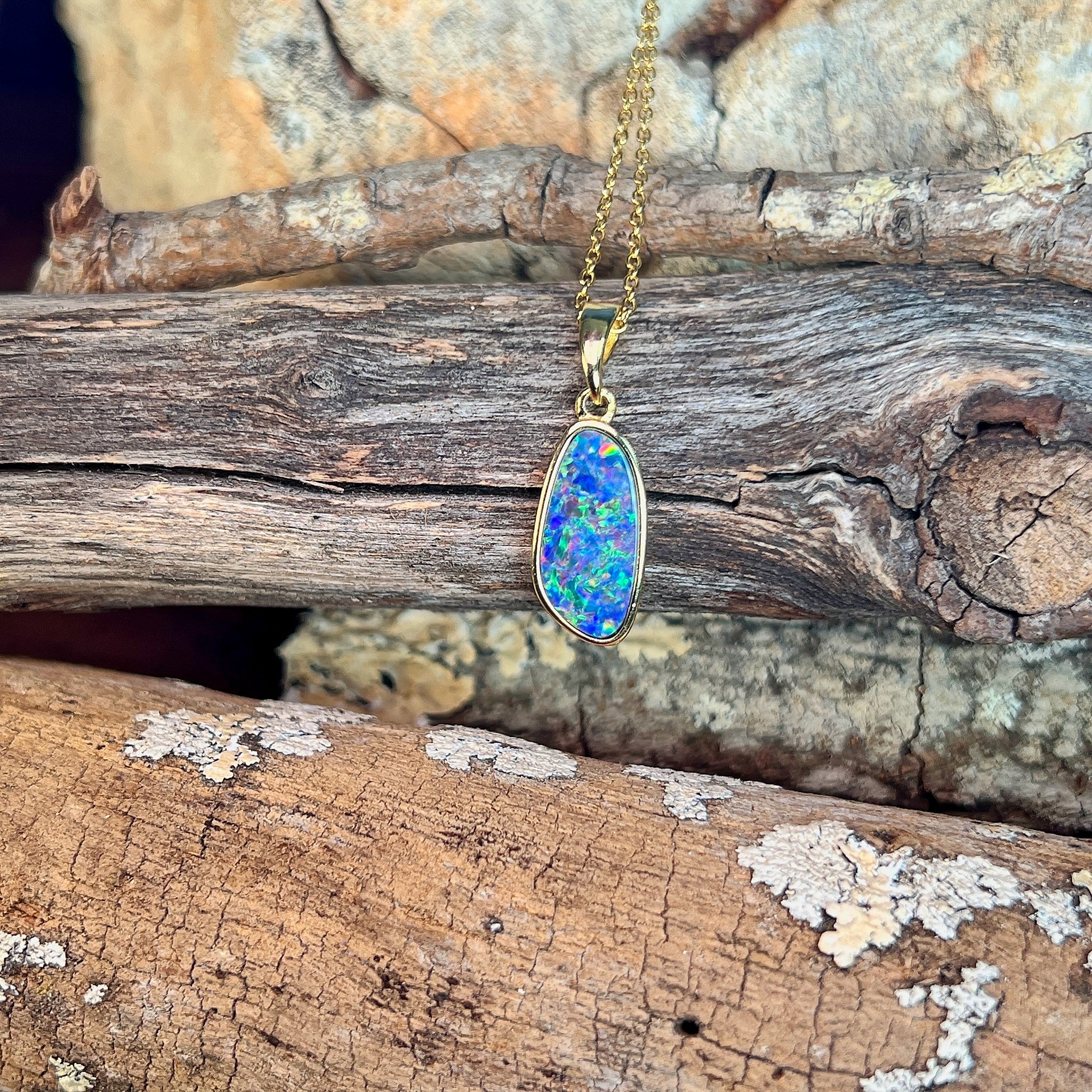 freeform Australian opal doublet pendant in yellow gold-plated silver, blue, red and yellow play-of-colour