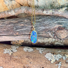 blue, red and yellow play-of-colour in a 15 x 7mm freeform Australian opal doublet pendant