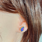 freeform Australian opal doublet earrings in yellow gold-plated silver, worn on the ear
