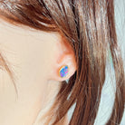 11 x 7.5mm freeform Australian opal doublet earrings worn on the ear, yellow gold-plated silver