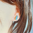 Worn Australian opal doublet earrings in yellow gold-plated silver, red, blue and green, 12 x 6mm