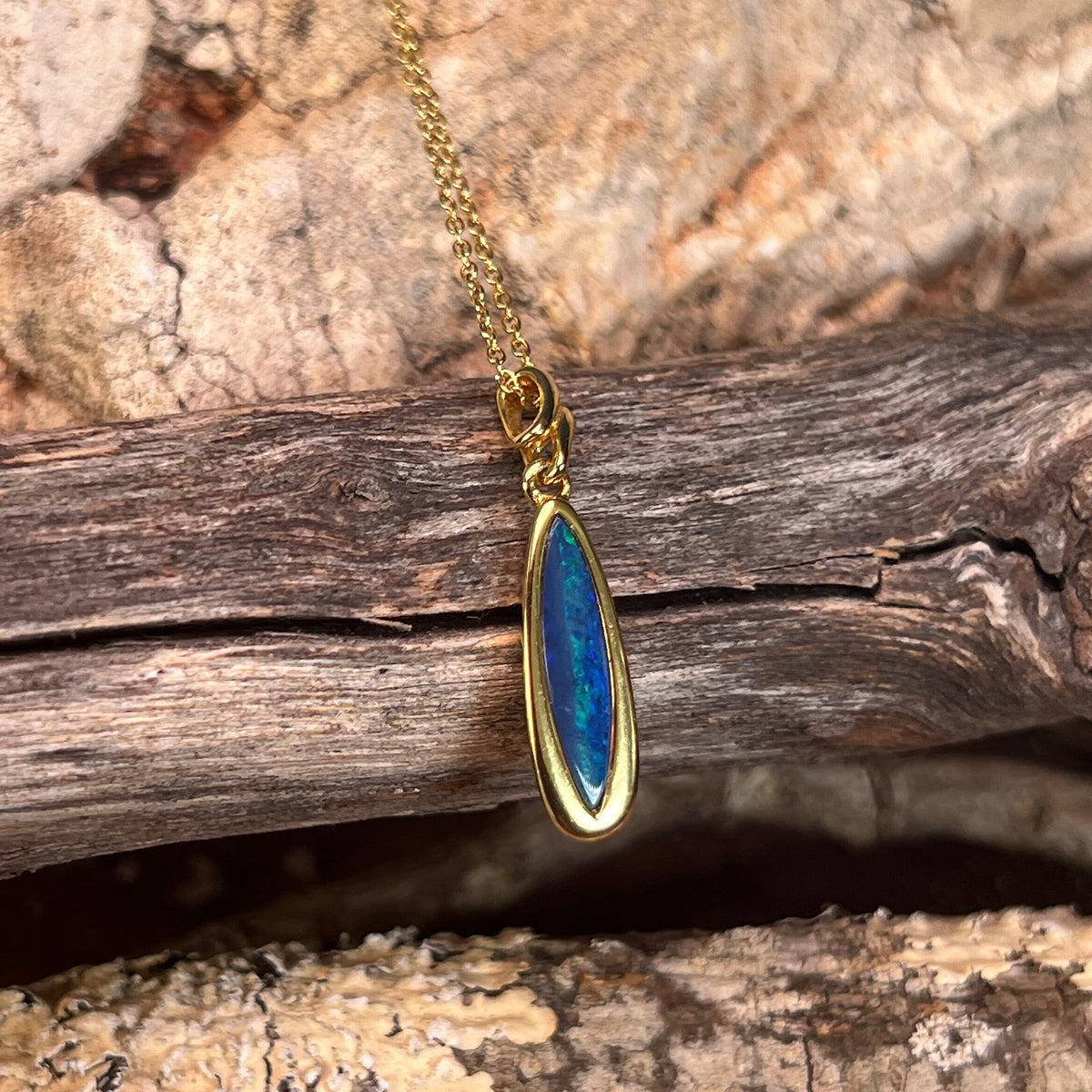 blue and green play-of-colour in a 17 x 5mm marquise Australian opal doublet pendant