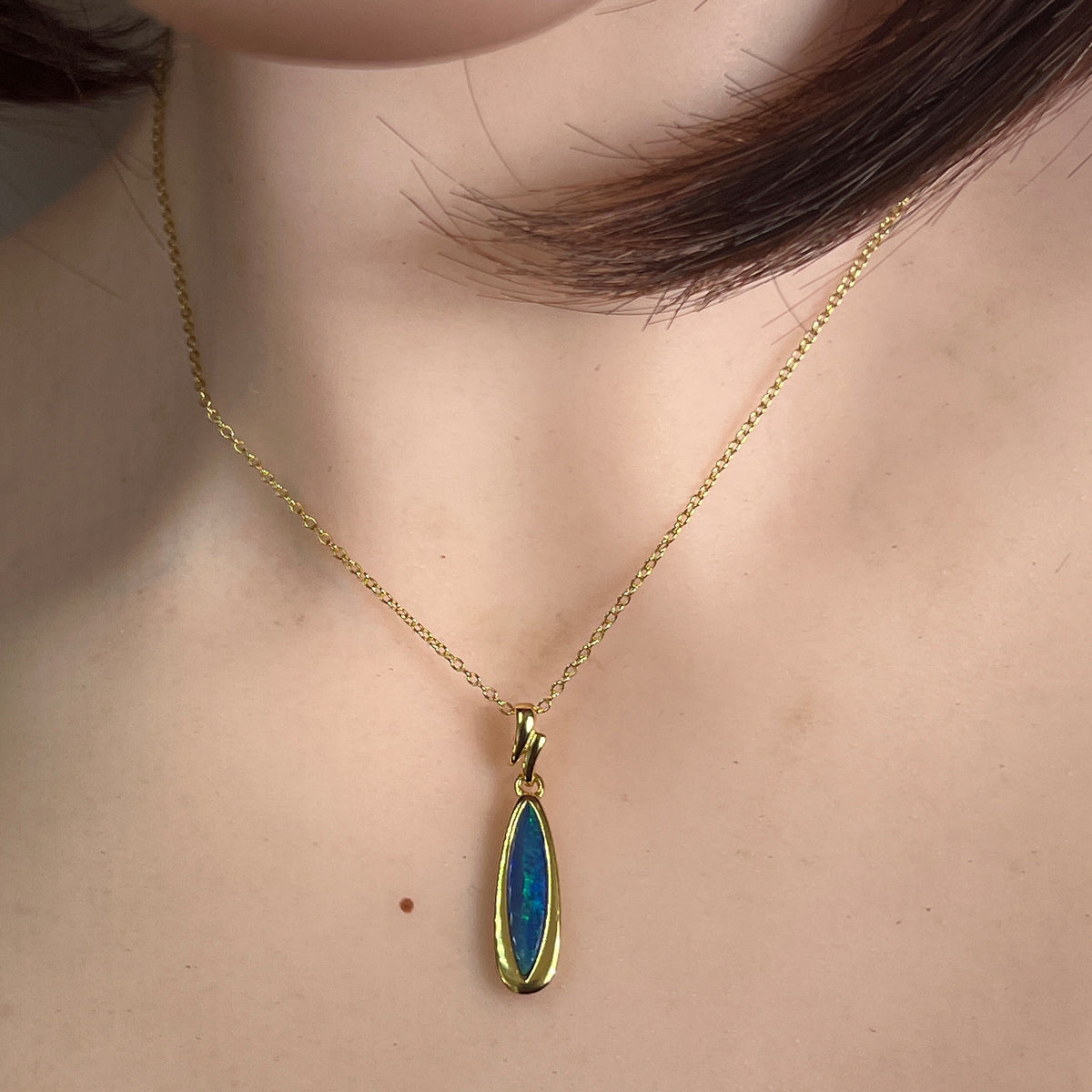 17 x 5mm marquise Australian opal doublet pendant worn at the neck, yellow gold-plated silver
