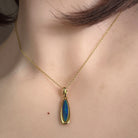 Australian opal doublet pendant worn at the neck, yellow gold-plated silver, 17 x 5mm marquise stone