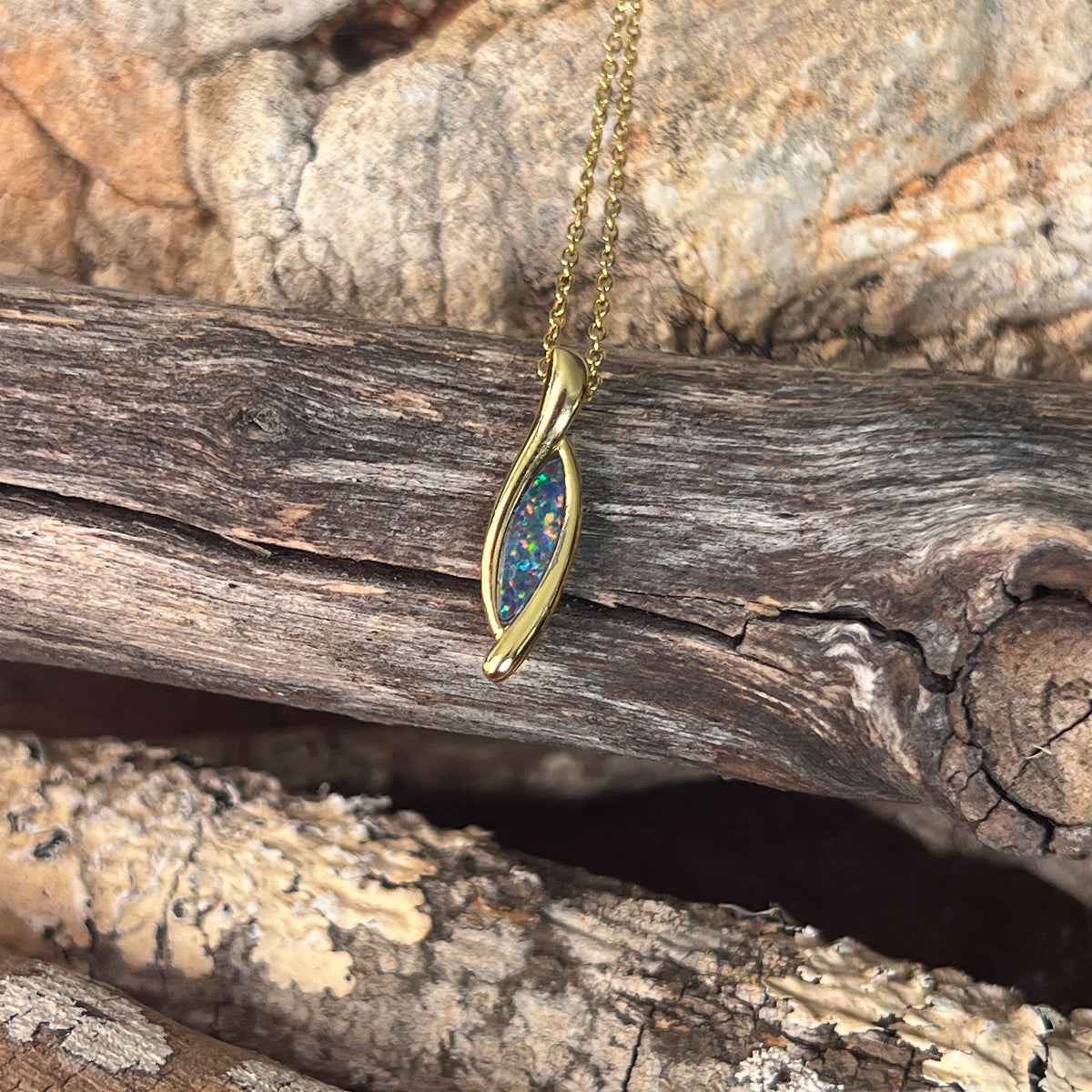 blue and green play-of-colour in a 12 x 4mm marquise Australian opal doublet pendant