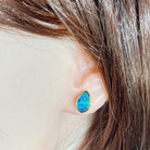 11 x 7.5mm marquise Australian opal doublet earrings worn on the ear, yellow gold-plated silver