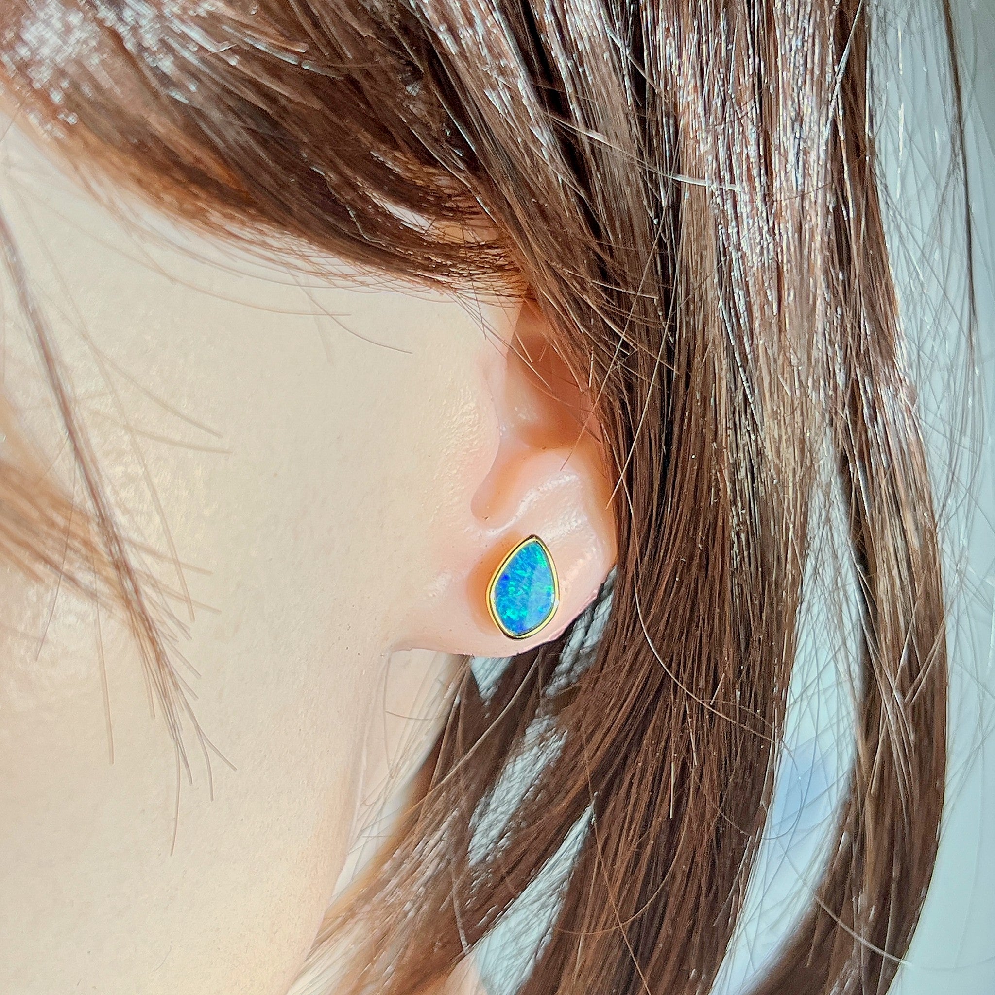Worn Australian opal doublet earrings in yellow gold-plated silver, green and blue, 11 x 7.5mm