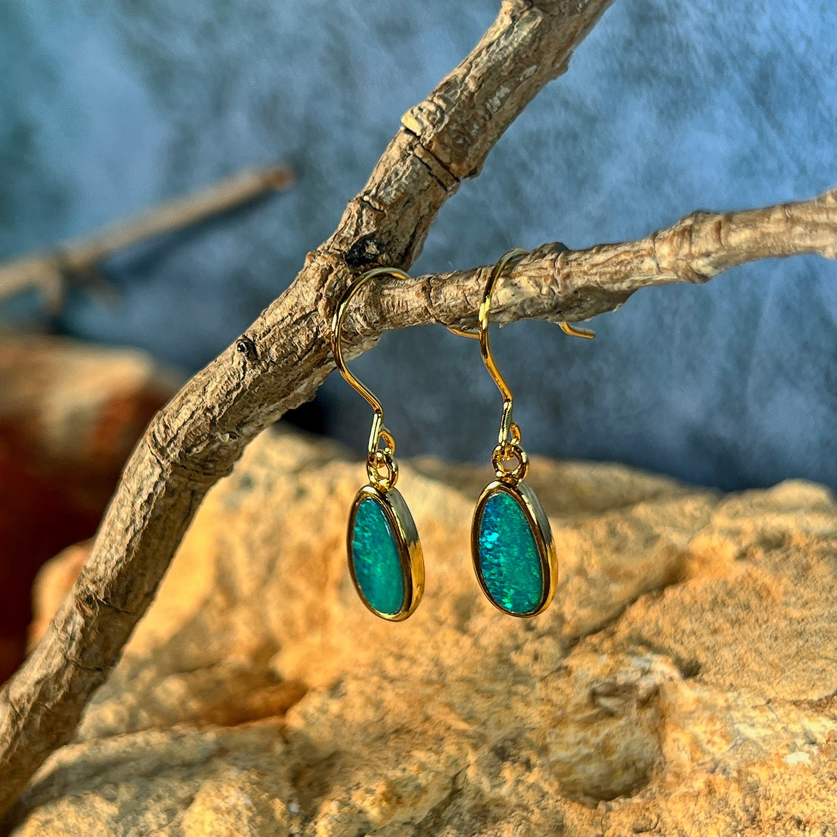 green and yellow play-of-colour in 11 x 6mm oval Australian opal doublet earrings