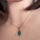 oval Australian opal doublet pendant in yellow gold-plated silver, worn at the neck