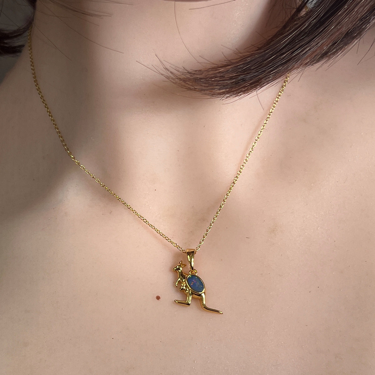 Worn Australian opal doublet pendant in yellow gold-plated silver, red, blue and yellow, 6 x 4mm