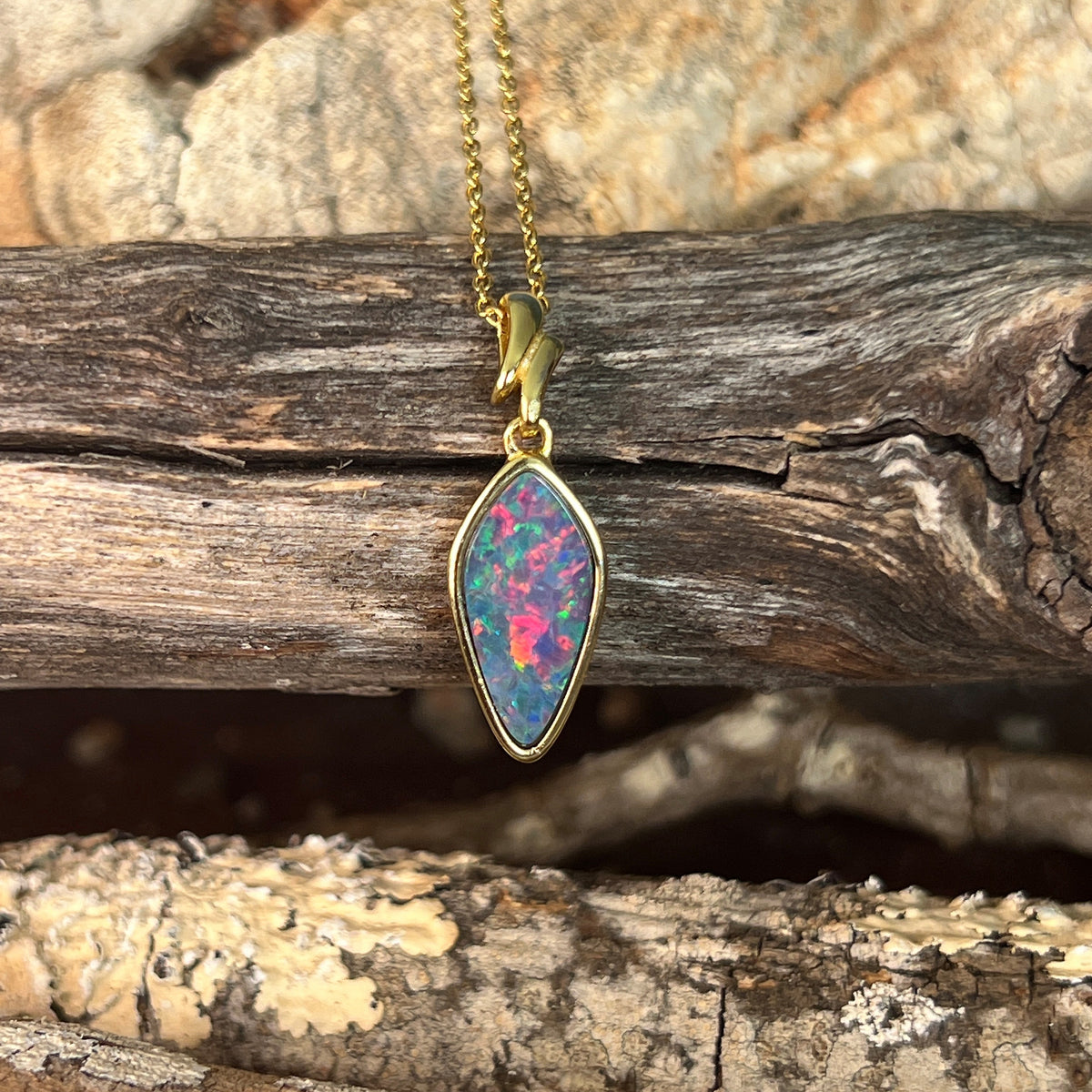 oval Australian opal doublet pendant in yellow gold-plated silver, red, blue and green play-of-colour