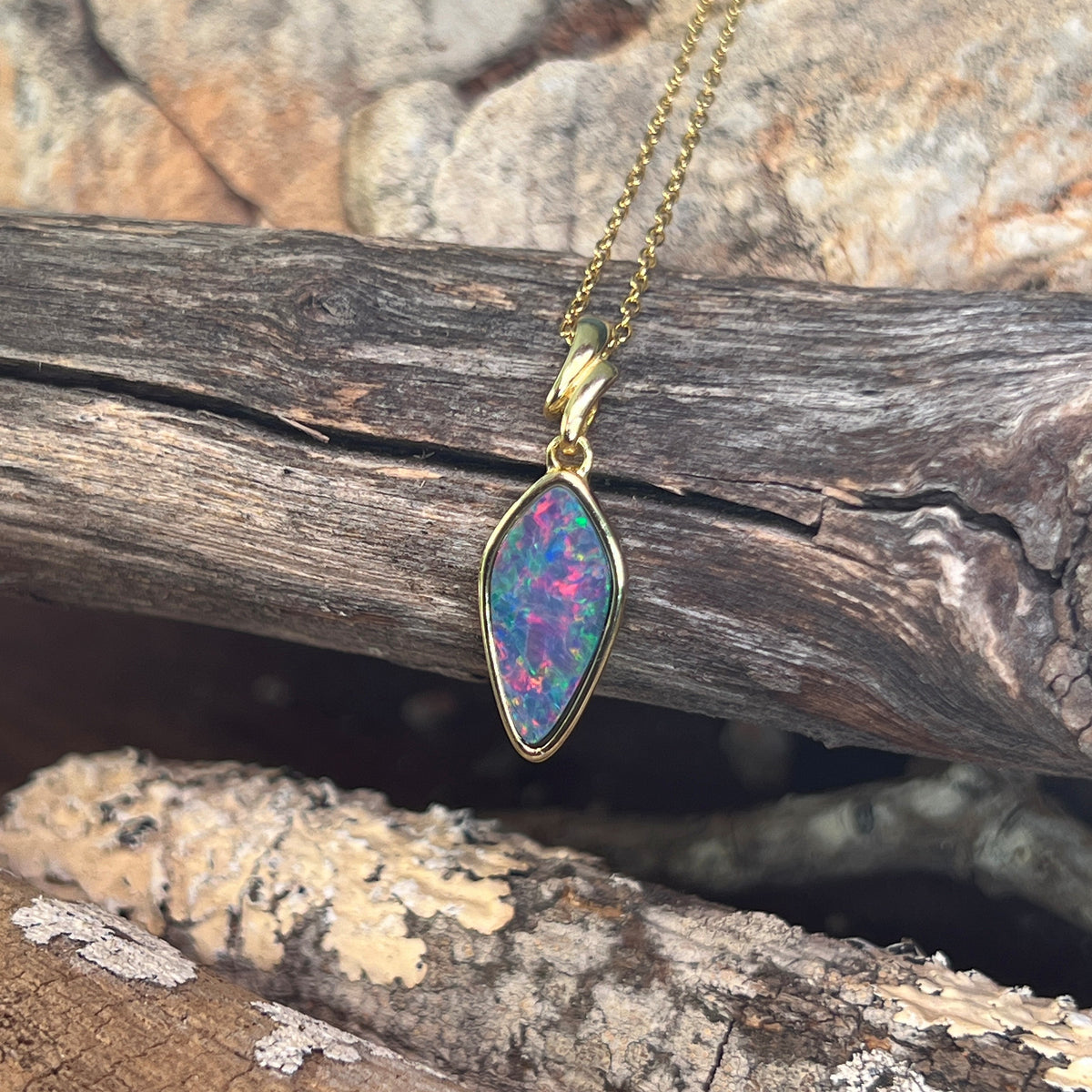 red, blue and green play-of-colour in a 16 x 8mm oval Australian opal doublet pendant