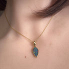 oval Australian opal doublet pendant worn, yellow gold-plated silver, red, blue and green
