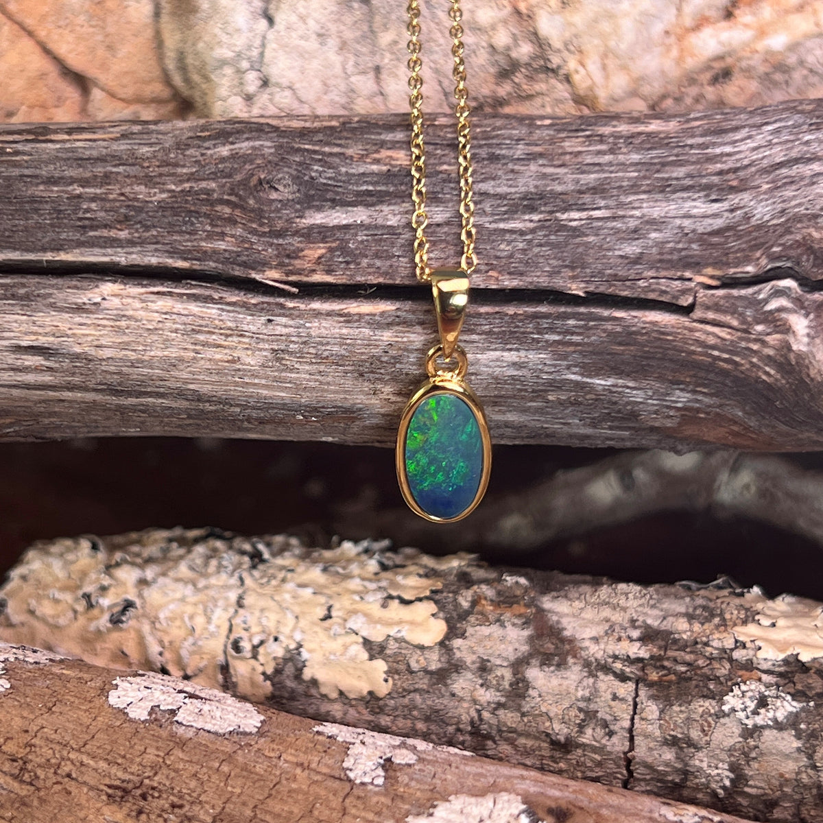 oval Australian opal doublet pendant in yellow gold-plated silver, blue and green play-of-colour
