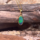 blue and green play-of-colour in a 12 x 6mm oval Australian opal doublet pendant