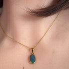 Worn Australian opal doublet pendant in yellow gold-plated silver, blue and green, 12 x 6mm
