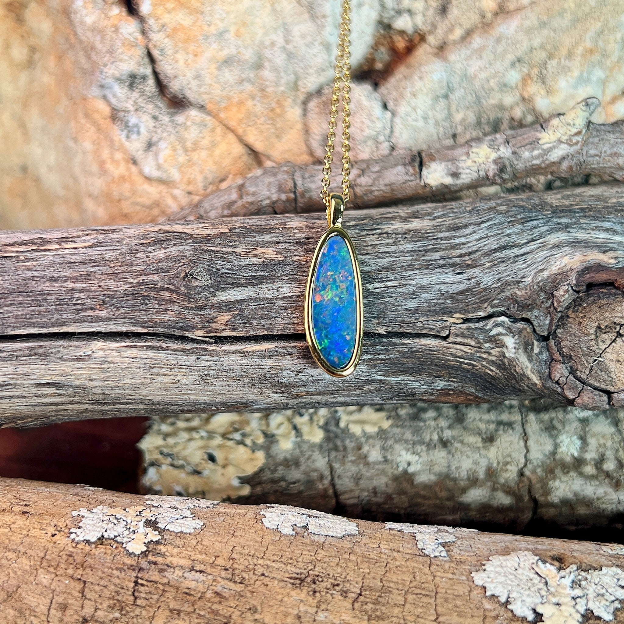 17 x 6mm Australian opal doublet pendant in yellow gold-plated silver, blue, red and yellow