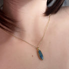 Australian opal doublet pendant worn at the neck, blue, red and yellow play-of-colour