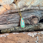 green, blue, red and yellow play-of-colour in a 17 x 6mm pear-shaped Australian opal doublet pendant