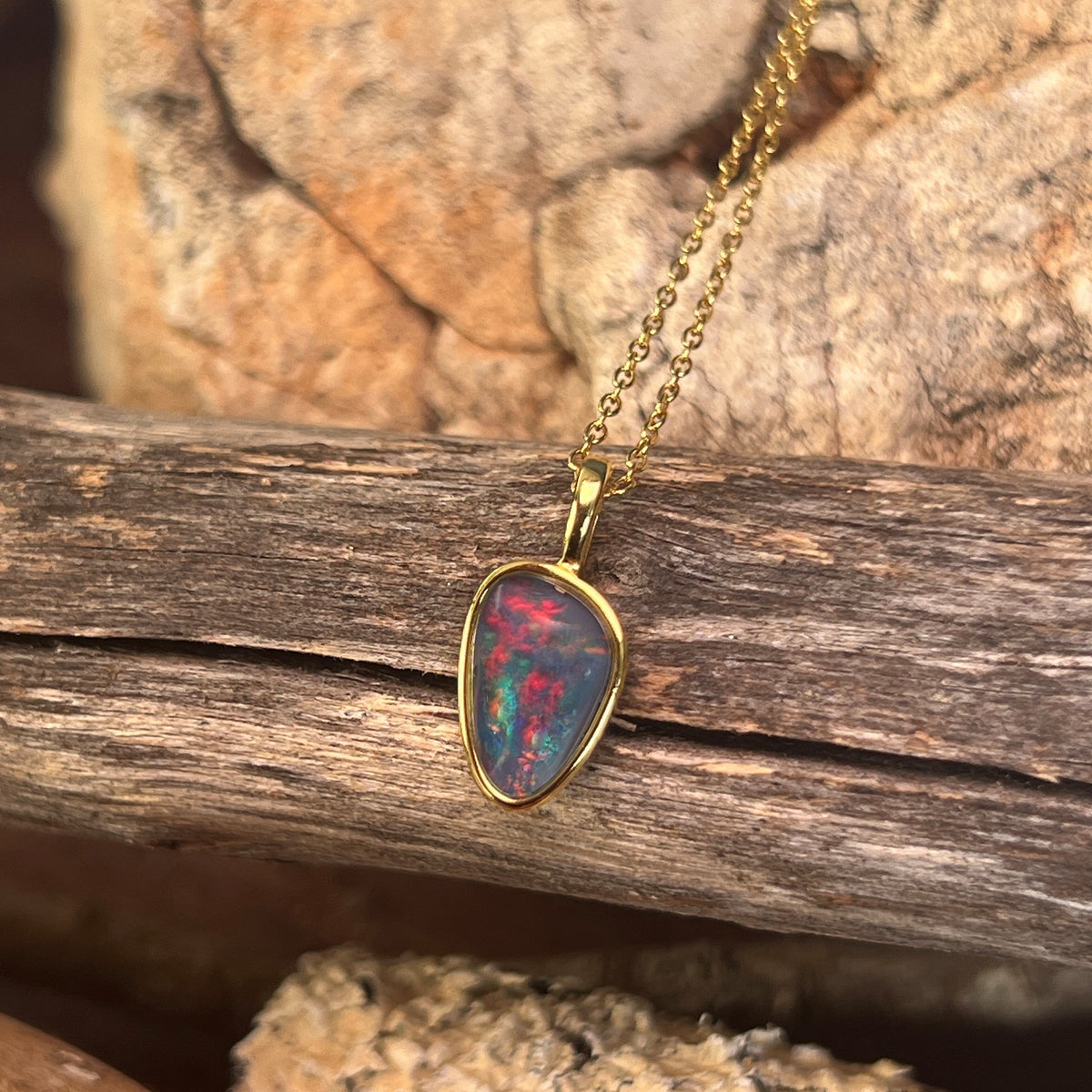 blue, red and green play-of-colour in a 12 x 8mm freeform Australian opal triplet pendant