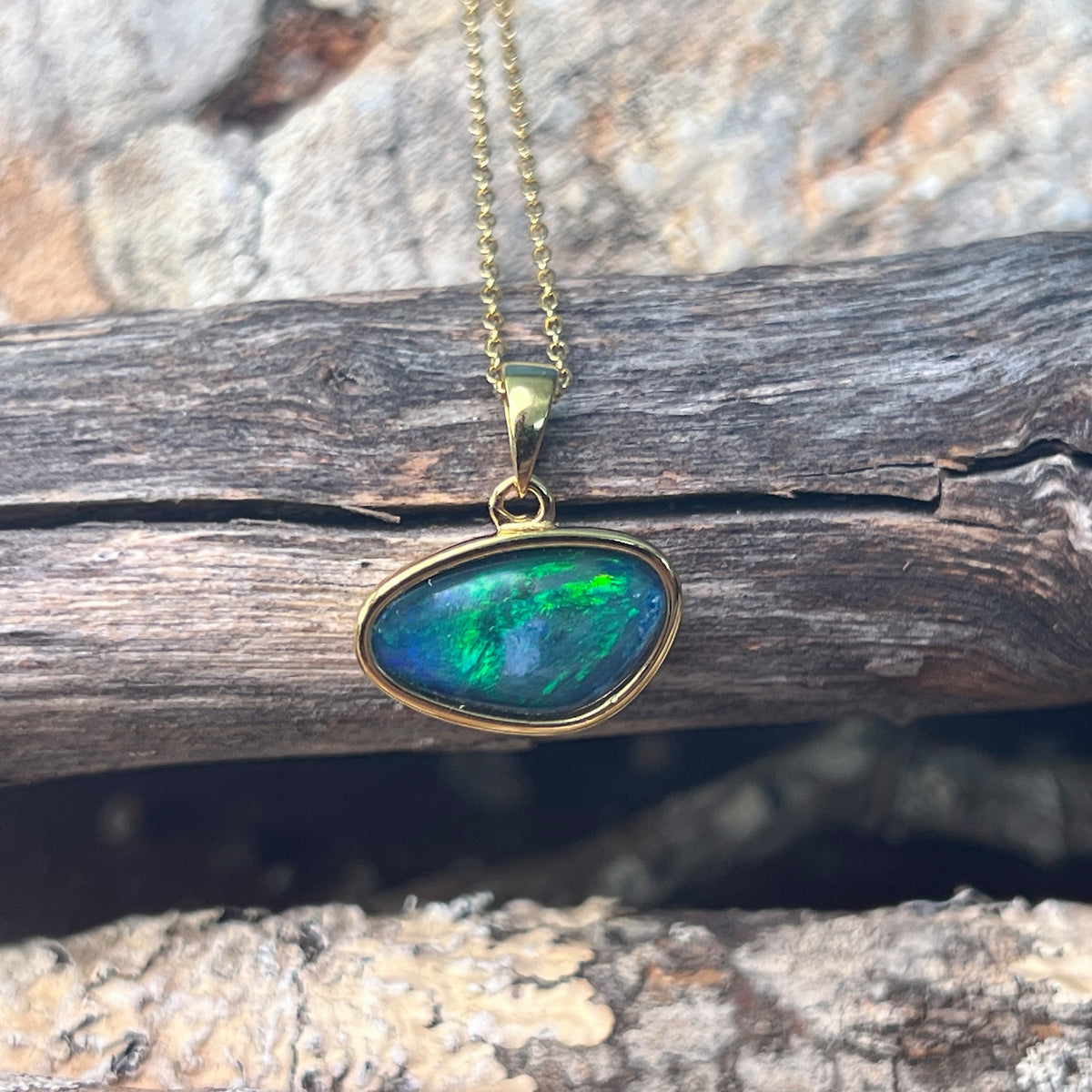 freeform Australian opal triplet pendant in yellow gold-plated silver, blue and green play-of-colour