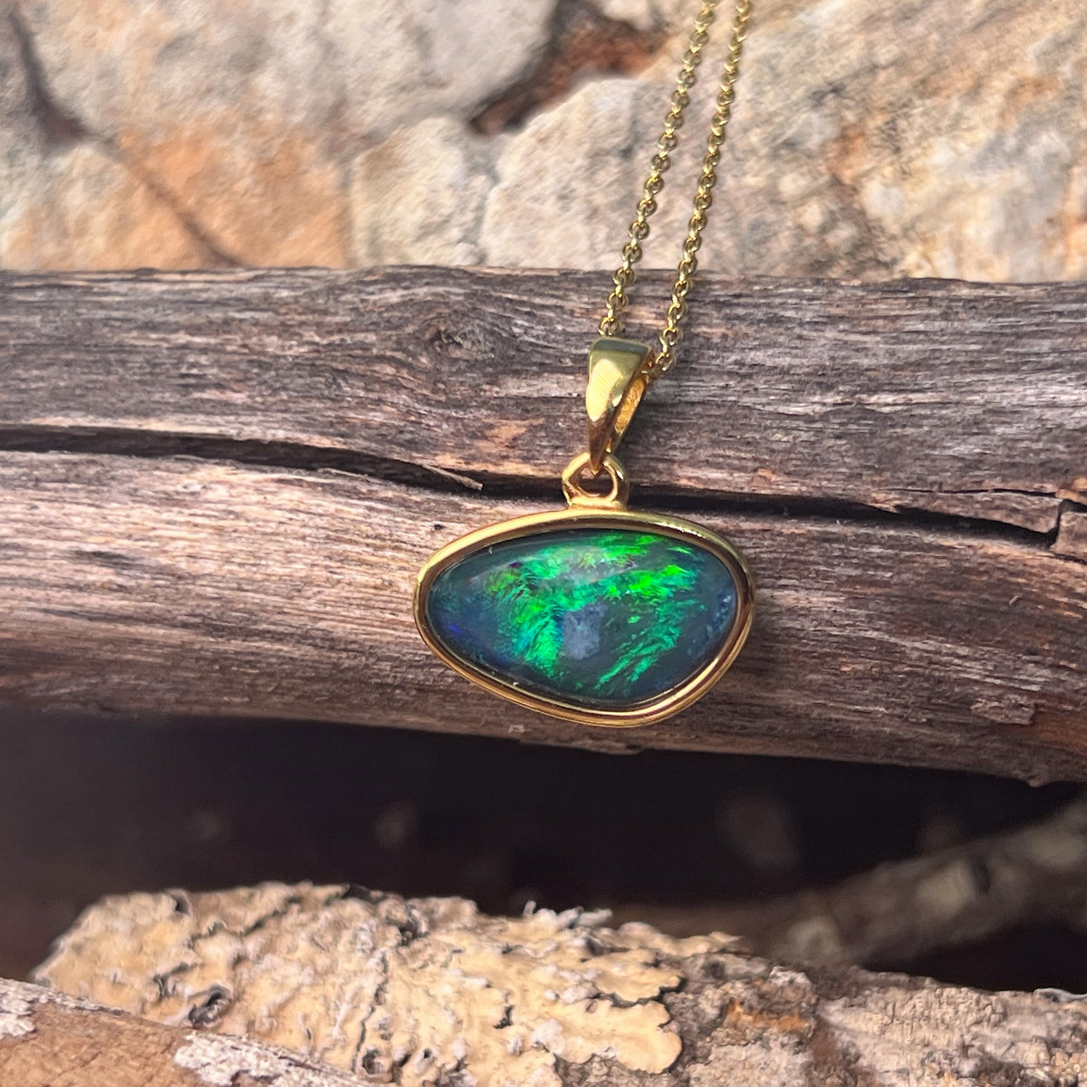 blue and green play-of-colour in a 16 x 10mm freeform Australian opal triplet pendant