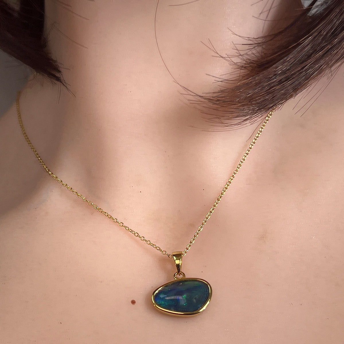 Worn Australian opal triplet pendant in yellow gold-plated silver, blue and green, 16 x 10mm