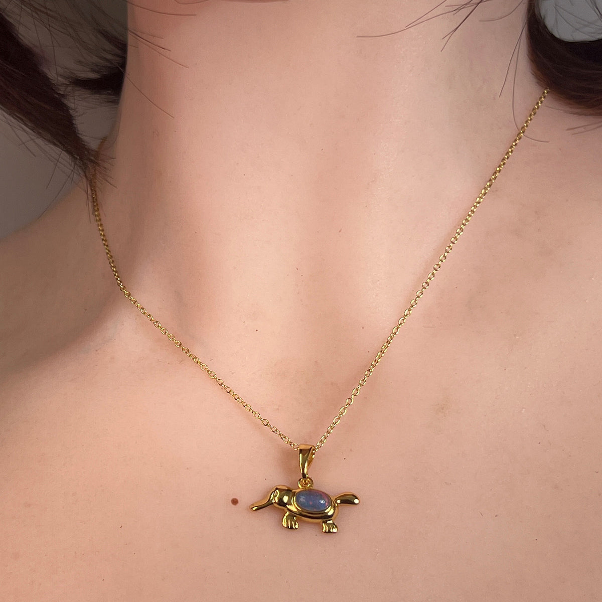 oval Australian opal triplet pendant in yellow gold-plated silver, worn at the neck