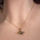 6 x 4mm oval Australian opal triplet pendant worn at the neck, yellow gold-plated silver