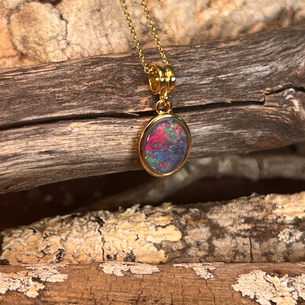 blue, red and green play-of-colour in a 14 x 10mm oval Australian opal triplet pendant