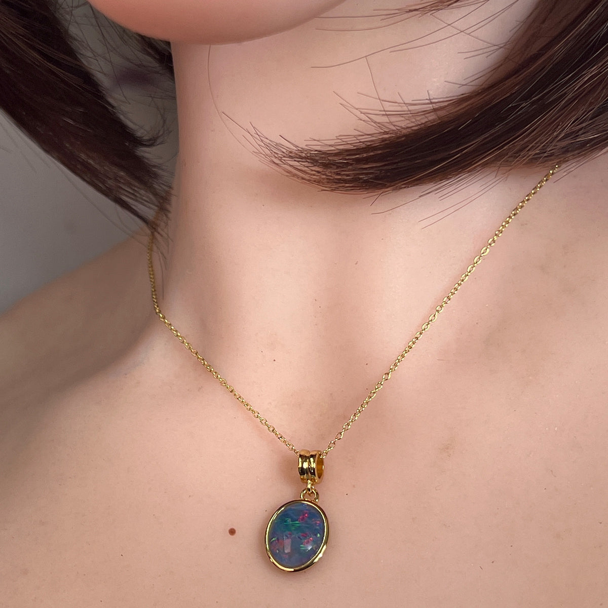 Australian opal triplet pendant worn at the neck, yellow gold-plated silver, 14 x 10mm oval stone
